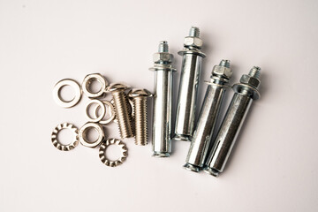 Metal drill screw on white background, construction industrial concept.