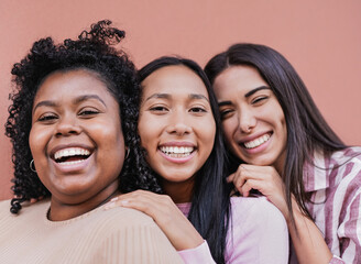 Cheerful multiracial women with different skin color looking in camera - Concept of friendship and...
