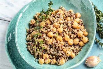 Close-up view of bowl of quinoa salad with chickpea. Buddha bowl with quinoa, chickpeas and thyme. Super food, Food recipe background. top view