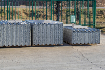 Obraz premium Economical and practical wave slate on sale. Building materials store. Topic: roofing materials, roofing, inexpensive materials