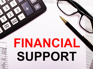 On the reports there is a calculator, glasses, a pen and a notebook with the inscription FINANCIAL SUPPORT