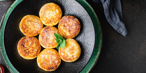 cheesecakes breakfast or dessert syrniki curd cottage cheese pancakes healthy meal top view copy space for text food background rustic image