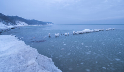 Fototapeta na wymiar Ice breakwaters in winter. sea winter blue landscape.
