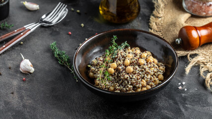 Buddha bow with quinoa salad with chickpeas and thyme. Super food on a dark background, top view