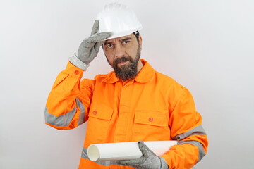 Portrait bearded man. Worker builder wearing hardhat  holding plans under arm