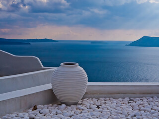 White pottery vase overlooking Aegean Sea Santorini Greece