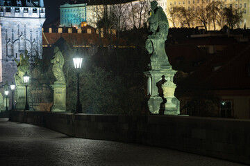 street lamp of Charles Bridge at night and Prague Castle in the background