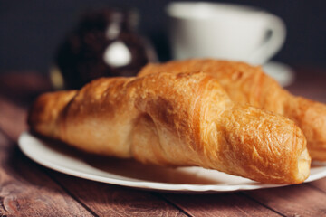 fresh croissants on a saucer table setting breakfast