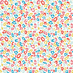 Happy colorful leopard skin spots in pink, green, yellow and red colors on white background. Vektor seamless pattern for kids fashion, T-shirts, fabrics, decorations, covers, wrapping, backdrops.