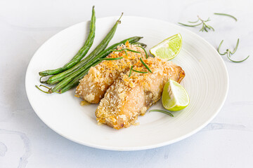 Baked Fish with Green Beans and Lemon Garnished with Rosemary