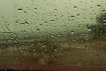 rain drops on car windshield forming beautiful texture pattern.