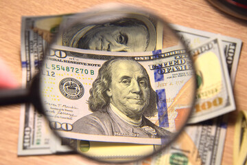 Business and finance. View of banknotes through a magnifying glass