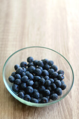 Bowl of blueberries on the table. Selective focus.