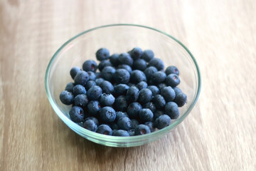 Bowl of blueberries on the table. Selective focus.