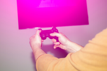 Man is playing video games at home. Gamepad in hands. Self isolation time. Entertainment during the quarantine period.
