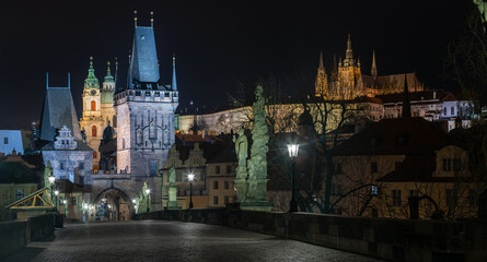 empty charles bridge at night and bridge towers in the center of prague