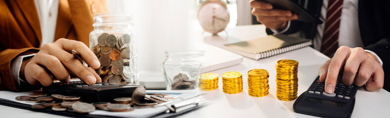 businesswoman holding coins putting in glass with using smartphone and calculator to calculate concept saving money for finance accounting