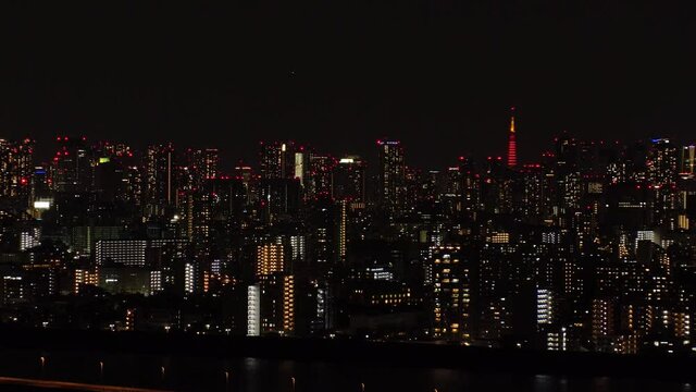 TOKYO, JAPAN : Aerial sunrise CITYSCAPE of TOKYO and MOUNT FUJI. Dawn sky, rising sun and buildings at downtown. Japanese metropolis and nature concept. Time lapse tracking video, night to morning.