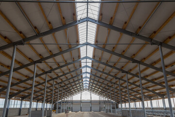 Building frame composition. Steel frame of the building with timber joists and sandwich panels on the roof. Modern construction of industrial buildings. Hangar construction