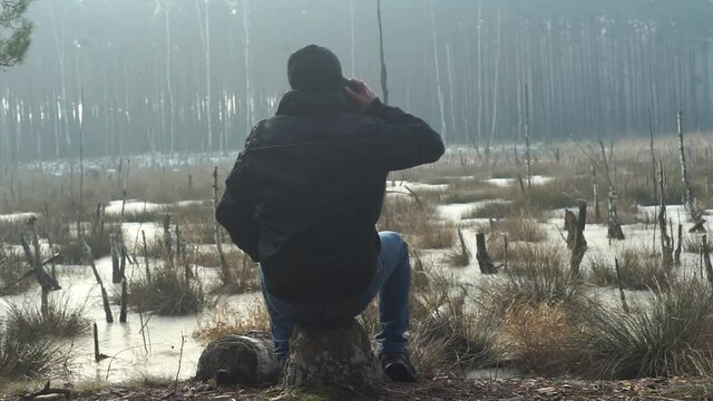 Mężczyzna w lesie rozmawia przez telefon