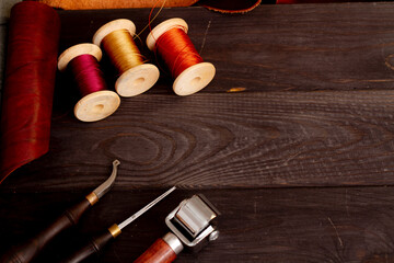 Sewing tools leather background. Threads for sewing leather by hand.