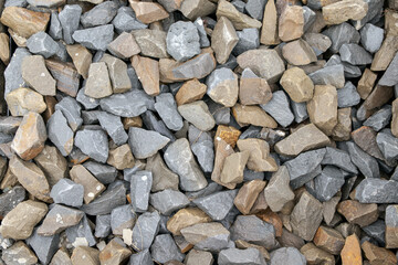 Natural chipped stone background. Natural gray granite chips, crushed stone or crushed stone texture, top view
