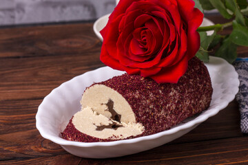 Eastern sweet halva with chocolate and rose powder on wooden background.