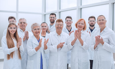 Fototapeta na wymiar group of medical professionals standing together applauding.