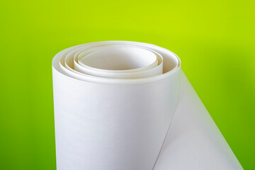 Roll of white paper on a green background.