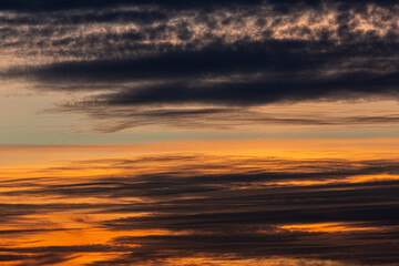 Fototapeta na wymiar Photo of cloudy sky at sunset with orange reddish sky