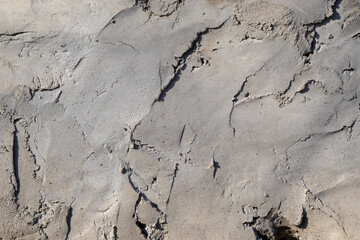 Sample of low-quality plaster. Substandard plaster. Texture of gray color.