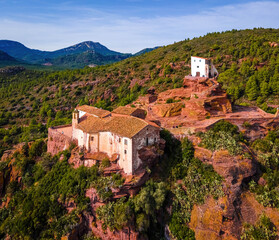 Fototapeta na wymiar Aerial view of Mare de Deu de la Roca de Mont-roig in Spain, vast hilltop hiking destination with rocky climbing areas, panoramic views and a historic church