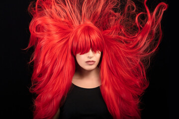 Hair care and styling concept with flying long red hair