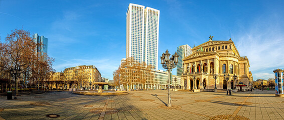 Panoramic view from the Opernplatz in Frankfurt with the historic Alte Oper building over the skyline during sunrise - obrazy, fototapety, plakaty