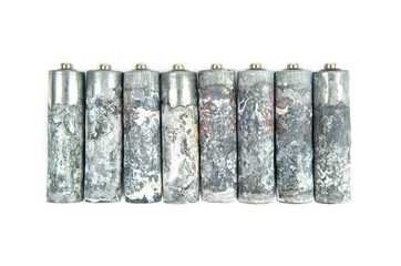 Heavily corroded AA batteries isolated on white