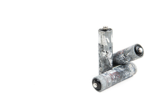 Used corroded AA batteries isolated on white