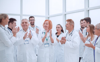 Fototapeta na wymiar group of diverse smiling doctors applauding together.