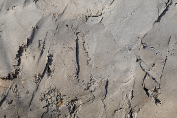 Sample of low-quality plaster. Substandard plaster. Texture of gray color.