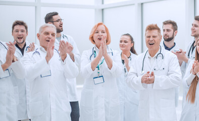 group of medical colleagues applauding their overall success.