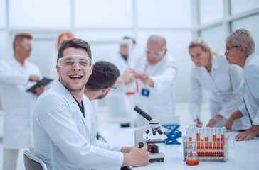 young scientist and his colleagues work in the laboratory.