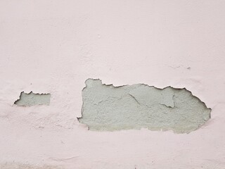 Paint peeling off the cement wall.