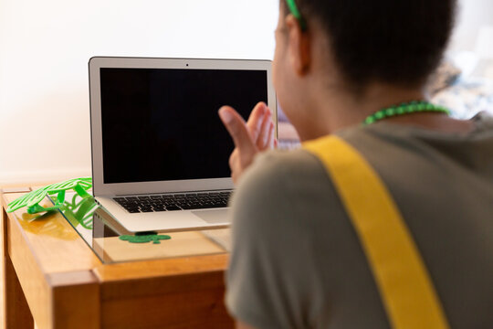 Mixed race woman celebrating st patrick's day making video call blowing kiss