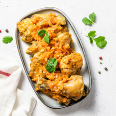 Oven baked chicken stew on a dish. Space for text, top view.