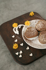 delicious cookies on a plate. hearts and yellow flowers on wooden board.