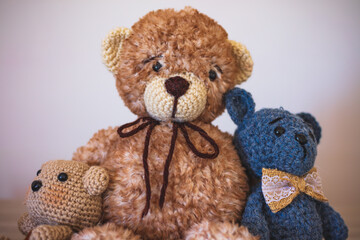 Cute wool teddy bears are lying on the table