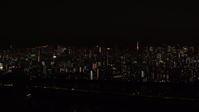 TOKYO, JAPAN : Aerial sunrise CITYSCAPE of TOKYO and MOUNT FUJI. Dawn sky, rising sun and buildings at downtown. Japanese metropolis and nature concept. Long time lapse zoom in video, night to morning