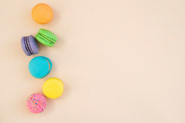 Tasty macarons on color background