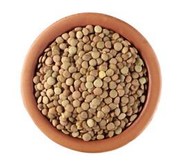 Pile of green lentils in clay pot isolated on white background, top view