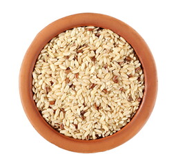 Integral, brown rice pile in clay pot isolated on white background, top view