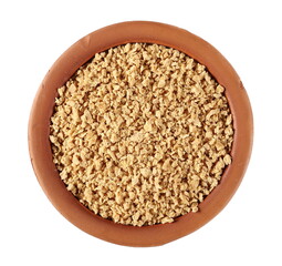 Soy flakes in clay pot isolated on white background, top view